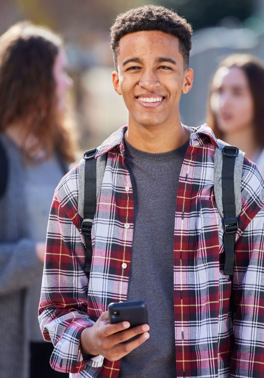 HighSchool Student holding phone Givefinity Mobile App for Volunteer Time Tracking