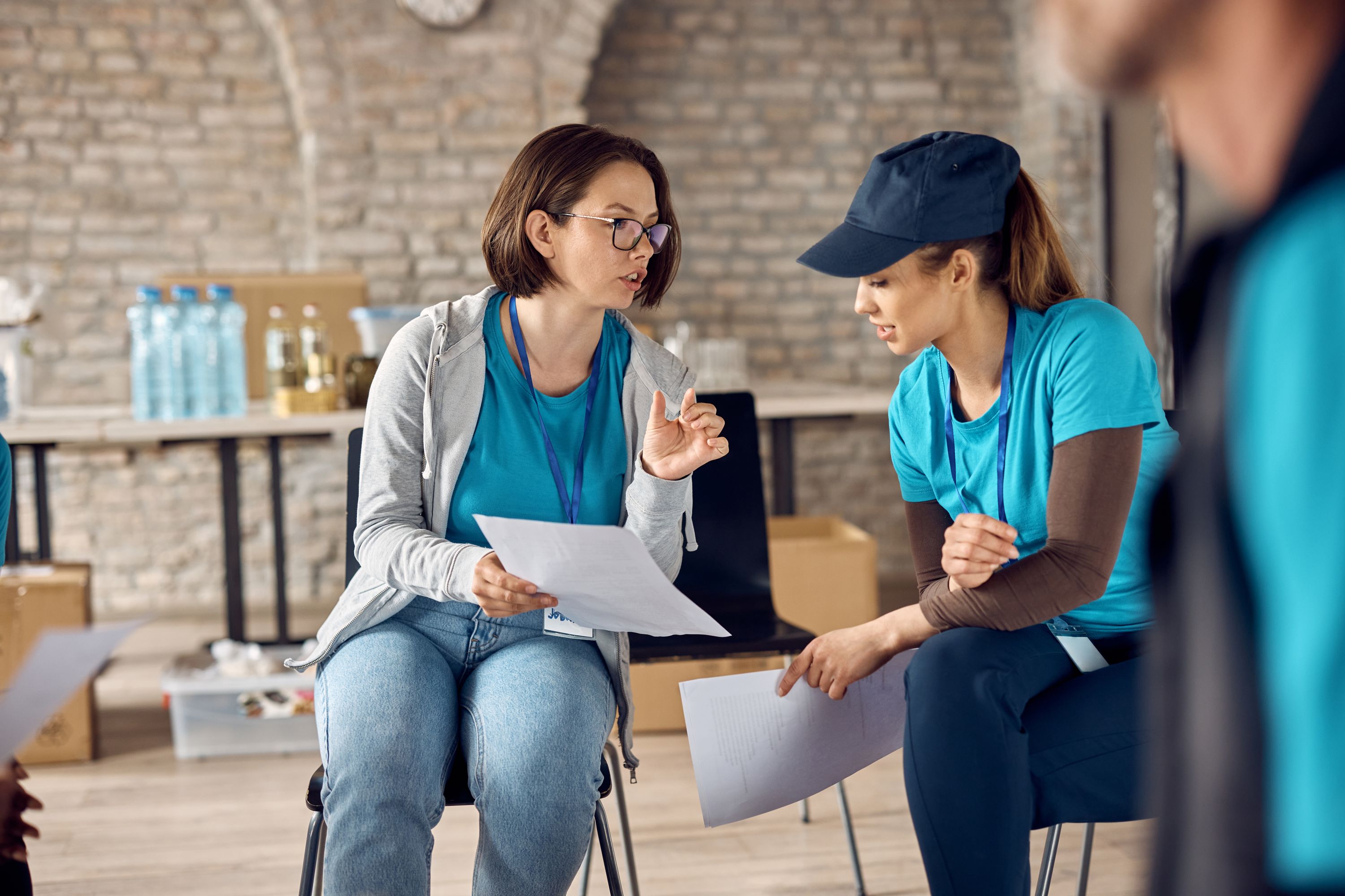 A volunteer coordinator and volunteer go over the plan for the day's activities.